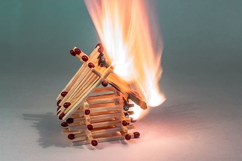 Matchsticks made into little home that was lit on fire