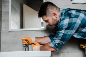 repairman working on bathroom after a flood